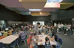 The children's reading room is animated by large windows, which admit light and the bustling activity outside, as well as a playful ceiling, illuminated by light fixtures with a sky motif. The design 