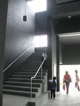 The entry atrium opens up off of a pedestrian path and car drop-off.