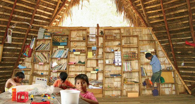 To compensate for minimal floor space, al bordE fabricated a lumber-and-bamboo bookshelf that acts as both storage and screen.