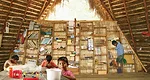 To compensate for minimal floor space, al bordE fabricated a lumber-and-bamboo bookshelf that acts as both storage and screen.