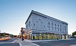 The Winters Building, circa 1924, sits on a corner lot. The design team removed years of grime, stucco, and other buildup on the facade, in addition to demolishing the old interiors. At night, large w