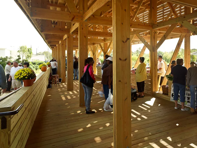 Farmers, craftsmen, and the public using the market.