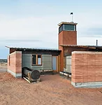 A rammed-earth house evokes the traditional hogan dwelling of the Navajo people.