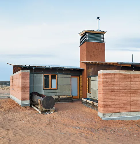 A rammed-earth house evokes the traditional hogan dwelling of the Navajo people.