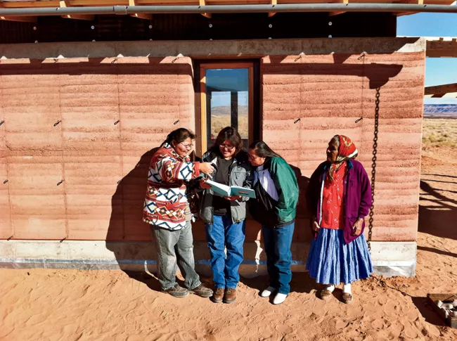 A rammed-earth house for Maxine Begay (far left) and her 10-year-old son, Maurice, evokes the traditional hogan dwelling of the Navajo people.