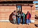 A rammed-earth house for Maxine Begay (far left) and her 10-year-old son, Maurice, evokes the traditional hogan dwelling of the Navajo people.