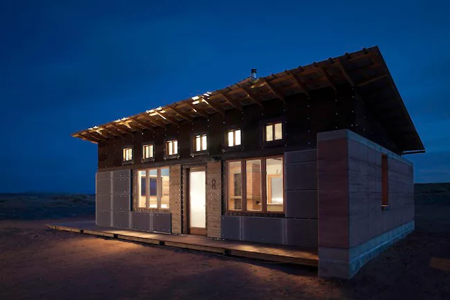 Recycled steel mesh screens from old aggregate sifters were used for the cladding above the basic cement board.