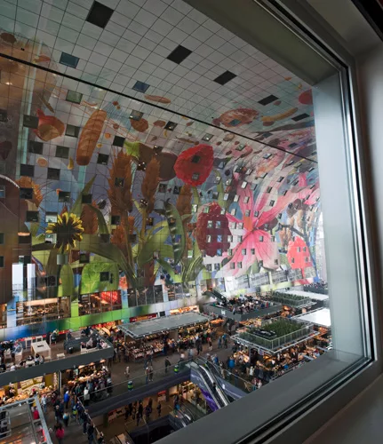 The interior-facing apartments have windows looking down on the activity of the market floor below.