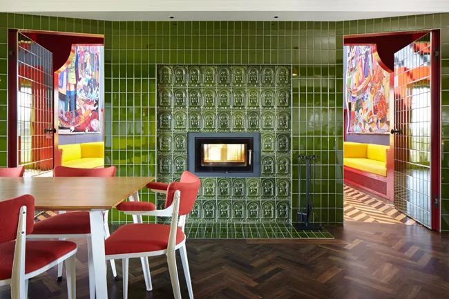 With custom tiles and herringbone floors, the kitchen and dining area opens to the living room.