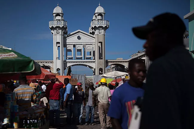 The clock tower's unstable legs were mostly rebuilt with steel, yet its top portion was carefully refurbished by Haitian craftsmen.