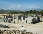 Haitian workers are learning U.S.-style construction, tempered by budget and supply-chain realities. The design, donated by Nicholas Clark Architects, uses natural ventilation and solar power to count
