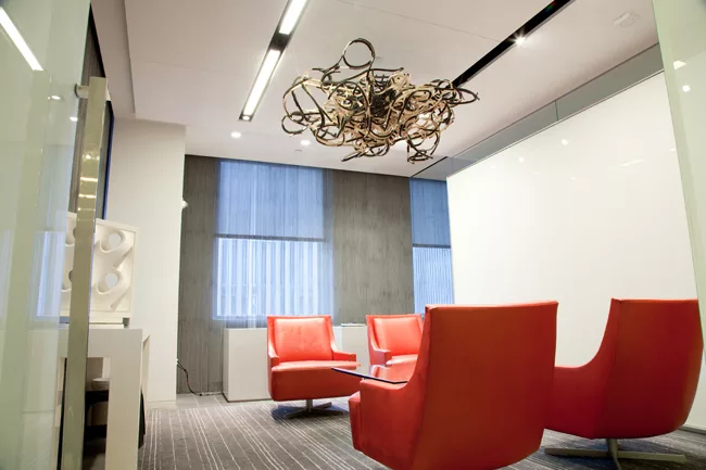 The wooden, nest-like sculpture suspended from the ceiling is another one of the site-specific pieces Talasnik created for the Gensler show. The accomplished artist, whose abstract work is inspired by