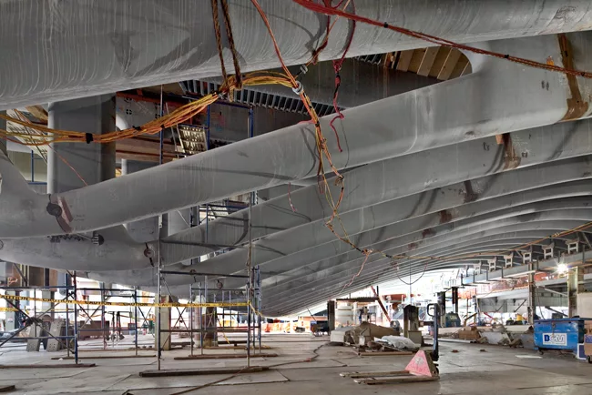 A temporary construction platform in the PATH station gives a close-up view of the arched steel ribs of the roof structure under the Memorial Plaza.