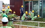 Students from the University of Tennessee work on the landscaping outside their house, <em>Living Light</em>.  
