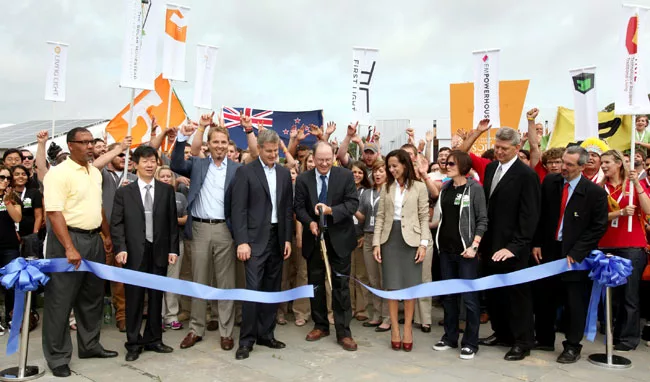 Richard King, director of the U.S. Department of Energy Solar Decathlon, center, officially marks the opening of event during a ribbon-cutting ceremony on September 22. The expo is open to the public 