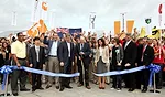 Richard King, director of the U.S. Department of Energy Solar Decathlon, center, officially marks the opening of event during a ribbon-cutting ceremony on September 22. The expo is open to the public 