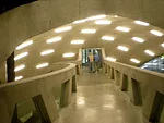 A walkway takes visitors under an interior dome to the building's auditorium.