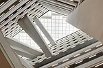 A full-height atrium features a transparent roof to allow ample daylight into the building. 