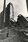 One of Pruitt-Igoe's 33 buildings stands half-demolished.