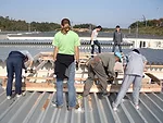 Built in an alleyway between two rows of housing, the new 175-square-foot meeting space features a wood frame and polycarbonate roof.