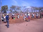 <p>In July 2009, Newman and his team from Engineers Without Borders NYC oversaw the design and construction of a small library for the community of Usalama in rural Kenya.  Here, the community wo