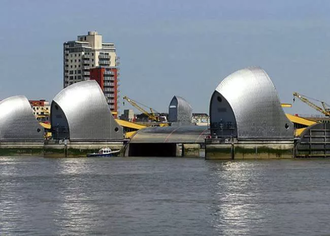 The Thames Barrier protects London. Designed by Rendel, Palmer and Tritton, the barrier consists of nine concrete piers and gates stretching 1,700 feet across the river. The piers house hydraulic mach