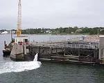The New Bedford Hurricane Barrier protects New Bedford, Massachusetts.  It was built to protect 1,400 acres of highly developed industrial and  commercial property. The barrier was completed in 1966, 