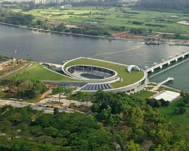 The Marina Barrage protects low lying areas of Singapore. The barrage is a 1,150-foot-long reinforced concrete structure, with nine 100-foot-wide steel crest gates. It lies across the Marina Channel,