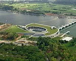 The Marina Barrage protects low lying areas of Singapore. The barrage is a 1,150-foot-long reinforced concrete structure, with nine 100-foot-wide steel crest gates. It lies across the Marina Channel, 