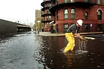 <p>A New York City worker clears a sewer drain in Lower Manhattan after Superstorm Sandy.</p>