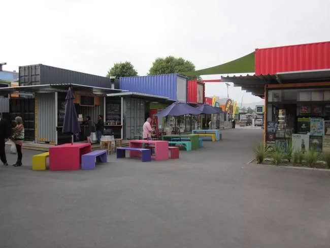Re:START is a temporary shopping center and public space in Christchurch, built of brightly colored, artfully arrayed shipping containers.