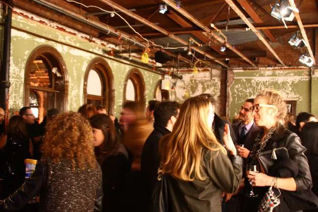 Event guests in a former office space at 5 Beekman Street.
