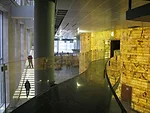 The Mariinsky II lobby during construction, showing the glass stair (right), bridge to the V.I.P. box (center), and back-it onyx wall that envelopes the performance hall.