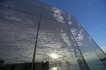 Clouds reflecting on the glass walls of the Exploratorium’s new Bay Observatory Gallery. <br />