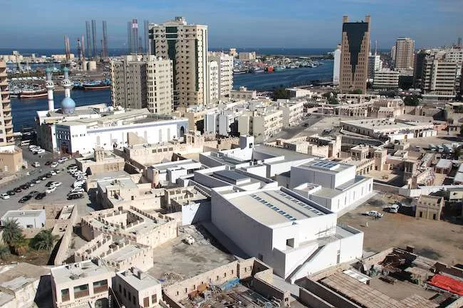 The 11th Sharjah Biennial sprawls through more than a dozen venues in and around the emirate’s Heritage Area on the eastern bank of Sharjah Creek. (The Persian Gulf is visible in the background.
