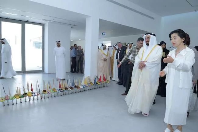 At the biennial's official opening, Sheikh Sultan bin Mohammed Al-Qasimi III, preceded by a troupe of television cameramen and followed by a large retinue, led a procession of guests through the maze