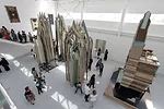Cathedral-like sculptures made from salvaged doors by Liu Wei soar in the large, steel building’s open space, the softness of its aging timber amplified by the indirect daylight.