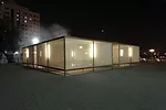 Studio Mumbai’s second pavilion, set up near the quay along Sharjah creek, encloses a fountain spraying mist inside a screened-in seating area.