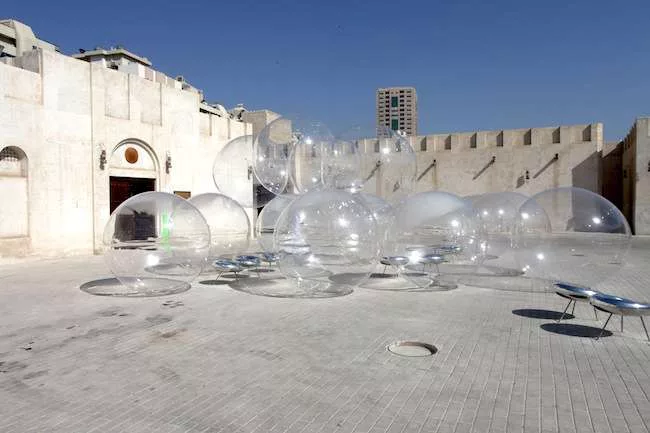 The Pritzker laureates’ outsized suds do little to shade—and the aluminum chairs scattered among them cause some serious glare—but the installation does provide an easy landmark in t