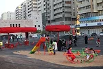 Unfortunately, Superflex placed its playground swings, benches, volleyball court, and other objects on a sea of asphalt running through the middle of a boulevard. The material retains daytime heat wel