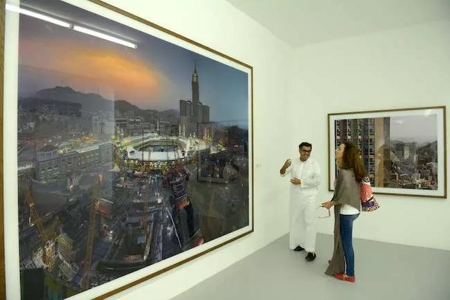 On the ground floor, photographs and an installation by Saudi artist Ahmed Mater critique the excesses on overdevelopment around the Masjid al-Haram in Mecca. Shown in monumental prints with an overpo