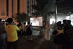 <p>Both foreign visitors and locals converge on an ad-hoc outdoor theater screening work by the Indian collective Camp. To make <em>From Gulf to Gulf to Gulf</em>, 2009-13, the artists gave cameras to