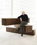 Rem Koolhaus sits on his 04 Counter, a rotating partition-cum-seating area from his Tools for Life collection for Knoll.