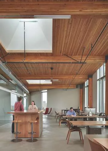 The building’s four upper levels have a heavy-timber structure of Douglas fir, with components such as laminated beams and wood-deck ceilings left largely exposed.