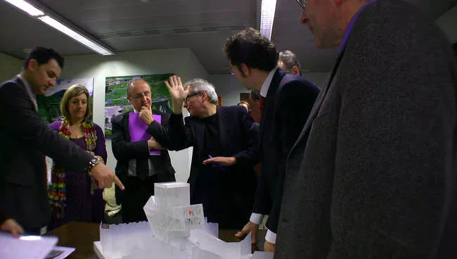 Still from <em>The Competition</em>: Dominique Perrault (with hand up) presents his scheme to the jury.