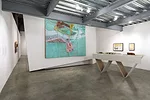 The installation includes an original 1976 model of <em>The RIver and the City</em>, a scheme by Studio Works (Craig Hodgetts and Robert Mangurian) for Minneapolis' Nicollet Island. The diagonal table