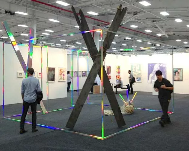 <strong>NADA</strong><br /> David Shaw’s <em>Collider</em> (2013), a “room” demarcated by aluminum coated in a holographic laminate, at the NADA fair.