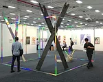 <strong>NADA</strong><br /> David Shaw’s <em>Collider</em> (2013), a “room” demarcated by aluminum coated in a holographic laminate, at the NADA fair.
