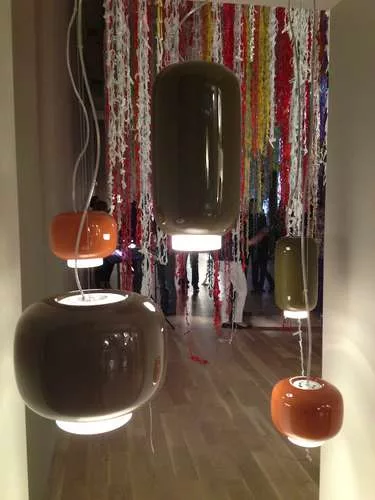 <strong>At the Foscarini Showroom</strong><br /> Ionna Vautrin lamps hang in front of a vine-like artwork by Stefano Arienti made from plastic grocery bags.