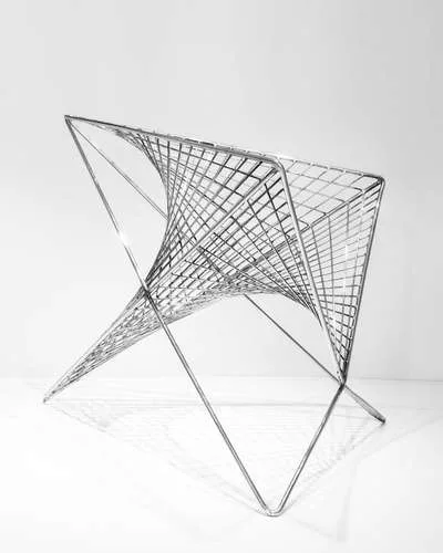 <strong>At ICFF</strong><br /> Los Angeles architect Carlo Aiello’s 'Parabola Chair.' Though it’s geometry curves in two directions, all of the chair’s components are straight and si